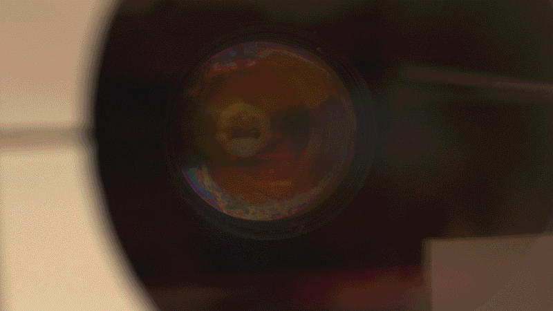 A projector shines a video loop onto liquid resin